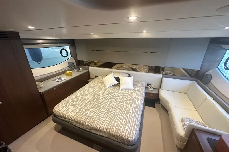  Yacht Photos Pics Luxurious bedroom interior of 2020 Princess S62 yacht with modern furnishings and elegant design.