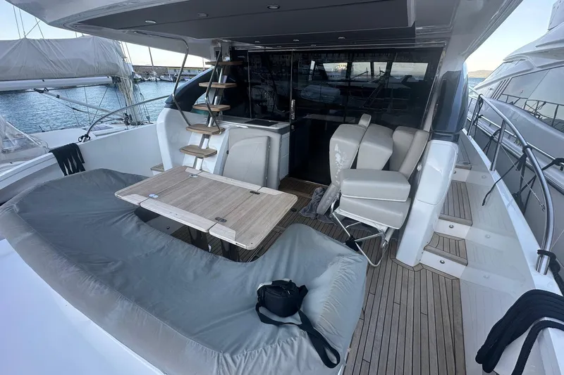  Yacht Photos Pics Luxurious 2020 Princess S62 yacht deck with seating, table, and ocean view.