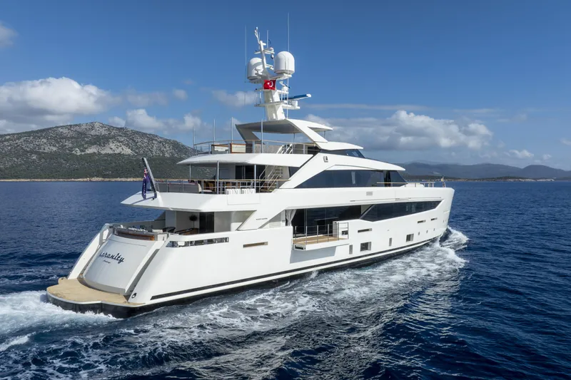 Serenity Yacht Photos Pics Luxurious 2015 Mondomarine SF40 yacht cruising on open sea with scenic mountain backdrop.