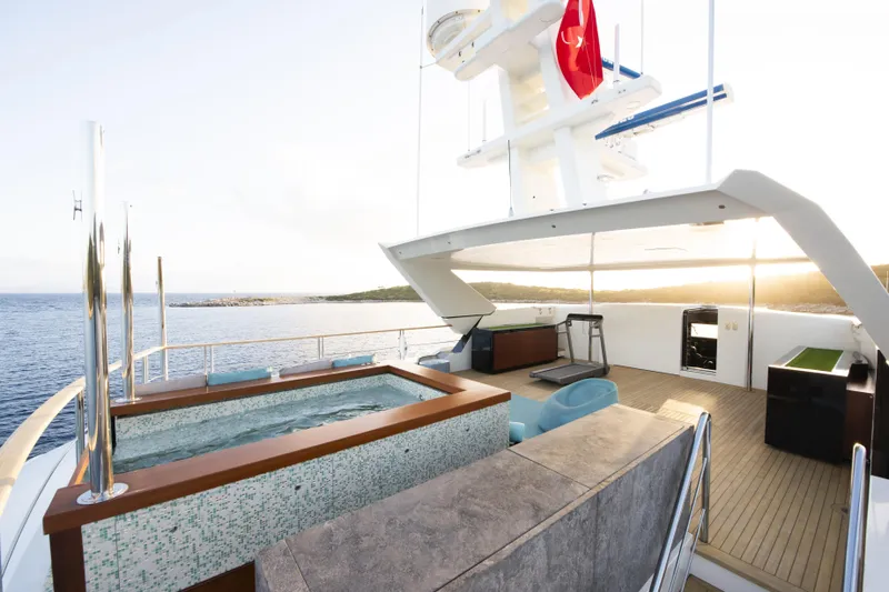 Serenity Yacht Photos Pics Luxurious Mondomarine SF40 yacht deck with jacuzzi, gym equipment, and ocean view, 2015 model.