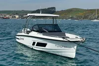 2022 Quarken 27 T-Top boat named "Flying Finn" on water, scenic coastal background.