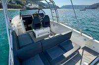 2022 Quarken 27 T-Top boat with sleek seating and scenic ocean view.