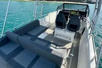 2022 Quarken 27 T-Top boat with sleek seating and modern design on clear blue water.
