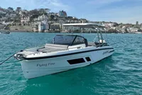 2022 Quarken 27 T-Top boat on turquoise water near coastal town.