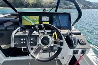 Cockpit of 2022 Quarken 27 T-Top boat with navigation screens and steering wheel.