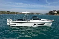 2022 Quarken 27 T-Top boat on blue water, side view.