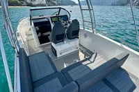 2022 Quarken 27 T-Top boat with sleek seating and scenic water view.