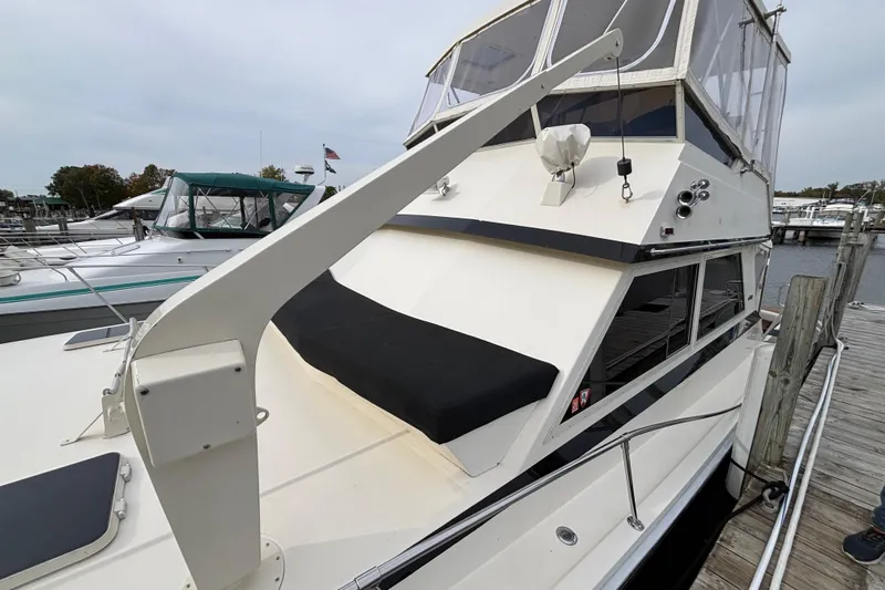  Yacht Photos Pics 1986 Viking 48 Convertible yacht docked at marina, featuring sleek design and spacious deck.