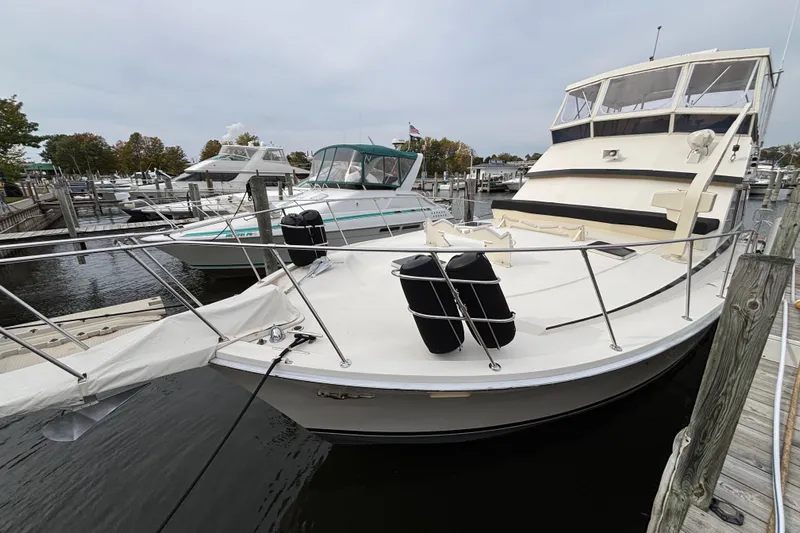  Yacht Photos Pics 1986 Viking 48 Convertible yacht docked at marina, featuring spacious deck and sleek design.