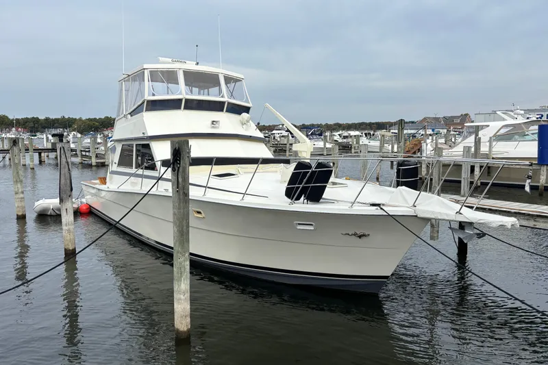  Yacht Photos Pics 1986 Viking 48 Convertible yacht docked at marina, overcast sky.