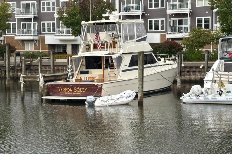  Yacht Photos Pics 1986 Viking 48 Convertible yacht docked in marina, surrounded by modern waterfront buildings.