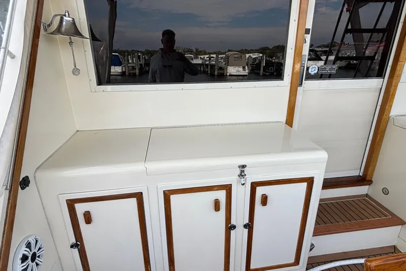  Yacht Photos Pics 1986 Viking 48 Convertible yacht interior with storage cabinets and wooden accents.