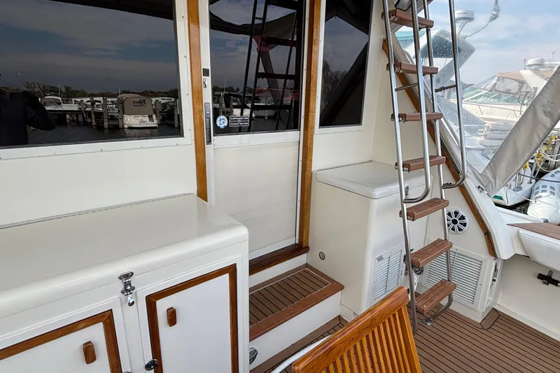 Yacht Photos Pics 1986 Viking 48 Convertible yacht interior with wooden accents and ladder.