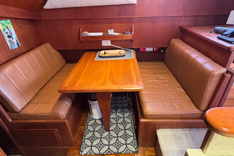  Yacht Photos Pics Interior of 1986 Viking 48 Convertible yacht with brown leather seating and wooden table.