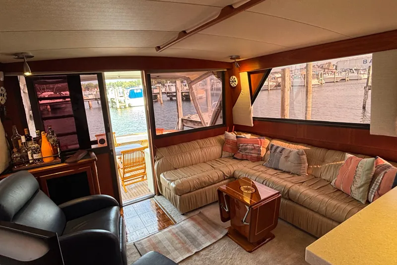  Yacht Photos Pics Luxurious interior of a 1986 Viking 48 Convertible yacht with plush seating and marina view.