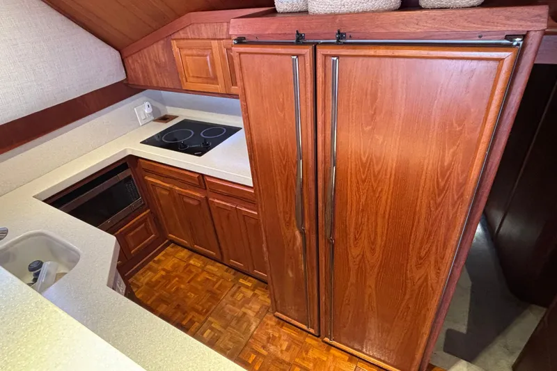  Yacht Photos Pics 1986 Viking 48 Convertible yacht kitchen with wood cabinetry and modern appliances.