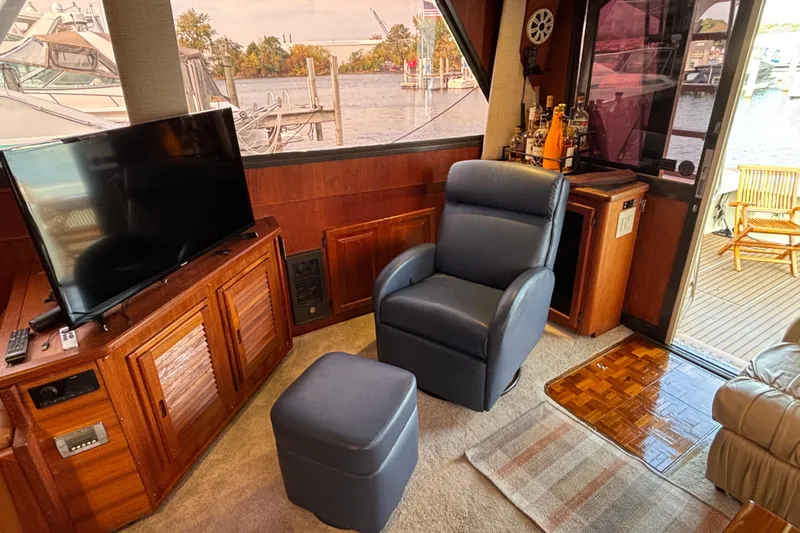  Yacht Photos Pics Interior of 1986 Viking 48 Convertible yacht with TV, chair, and scenic view.