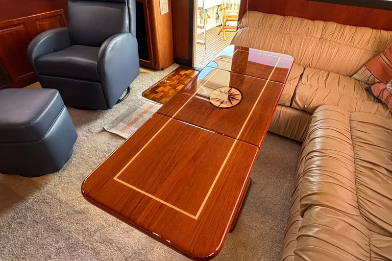  Yacht Photos Pics Luxurious interior of 1986 Viking 48 Convertible yacht with elegant wood table and plush seating.