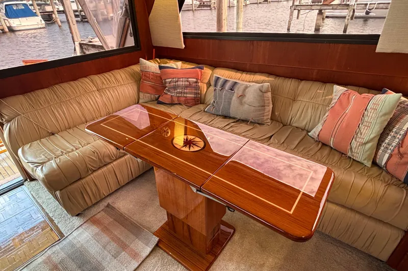  Yacht Photos Pics Interior of 1986 Viking 48 Convertible yacht with plush seating and elegant wooden table.