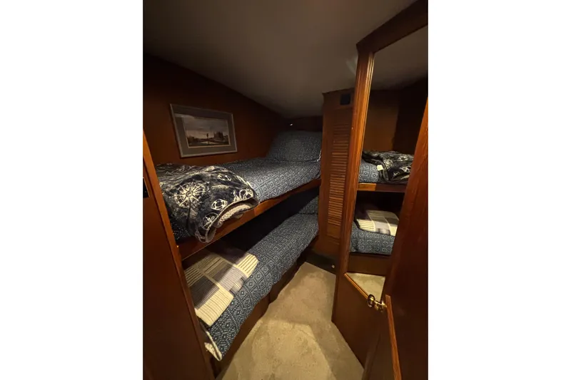 Yacht Photos Pics Cozy bunk beds in 1986 Viking 48 Convertible yacht cabin with nautical decor.