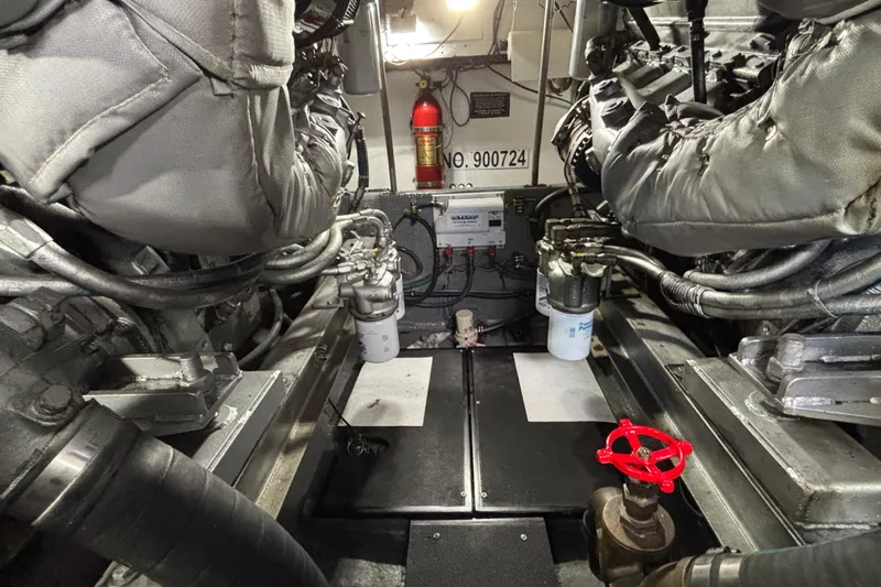  Yacht Photos Pics Engine room of a 1986 Viking 48 Convertible yacht, featuring dual engines and a fire extinguisher.