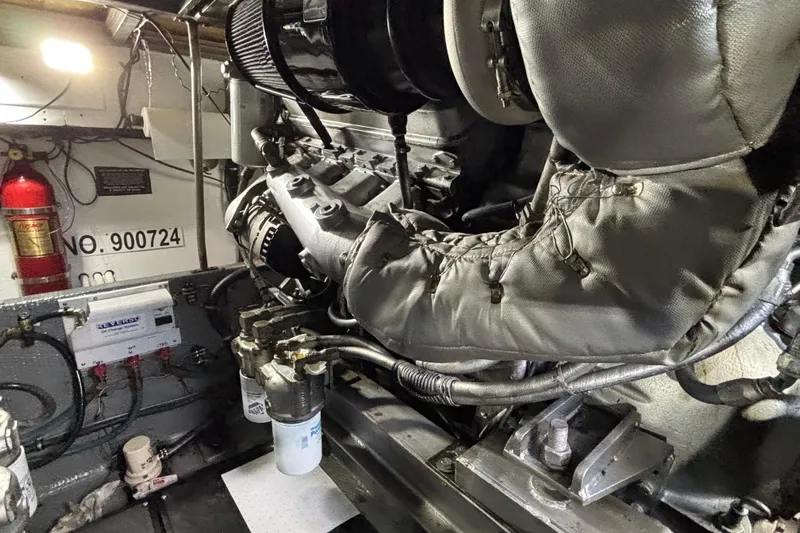  Yacht Photos Pics Engine room of a 1986 Viking 48 Convertible boat, featuring mechanical components and fire extinguisher.