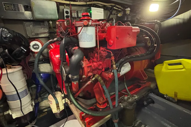  Yacht Photos Pics Engine room of a 1986 Viking 48 Convertible boat, featuring a red engine.