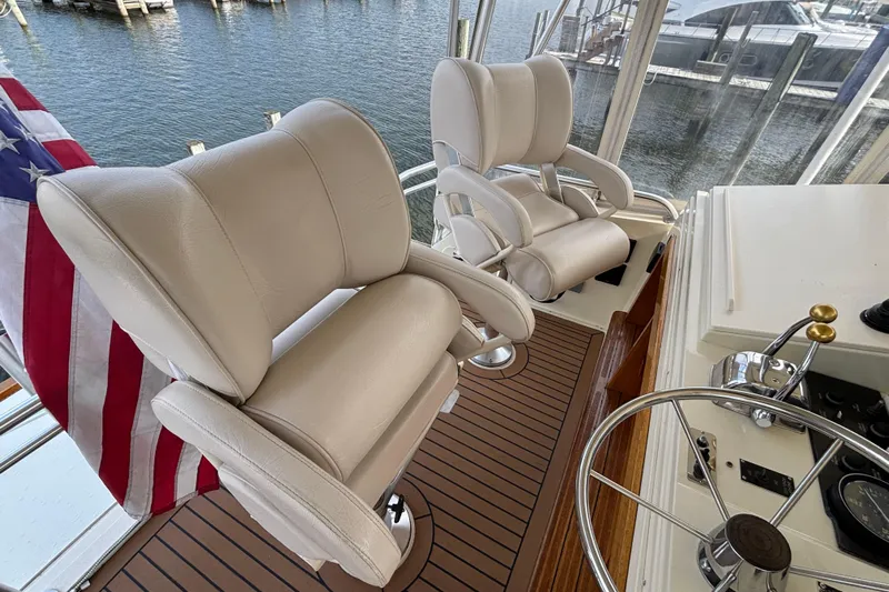  Yacht Photos Pics Luxury helm seating on 1986 Viking 48 Convertible yacht with American flag.