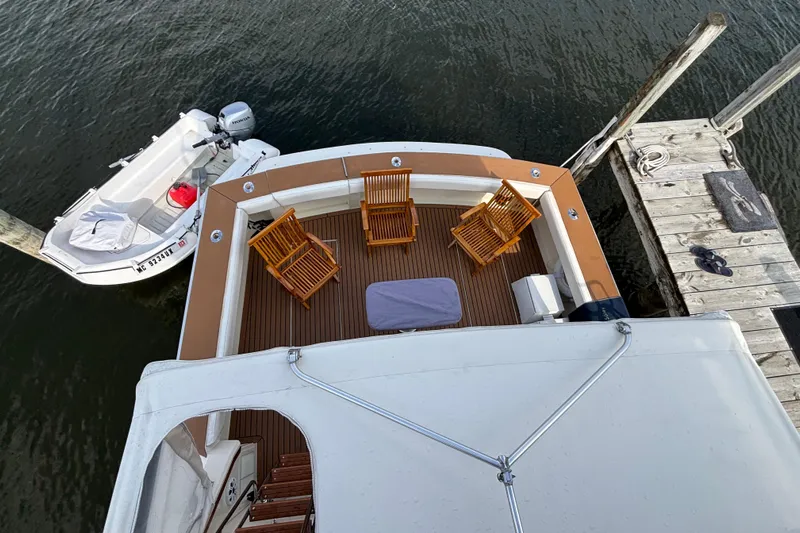  Yacht Photos Pics Aerial view of 1986 Viking 48 Convertible yacht deck with chairs and docked boat.