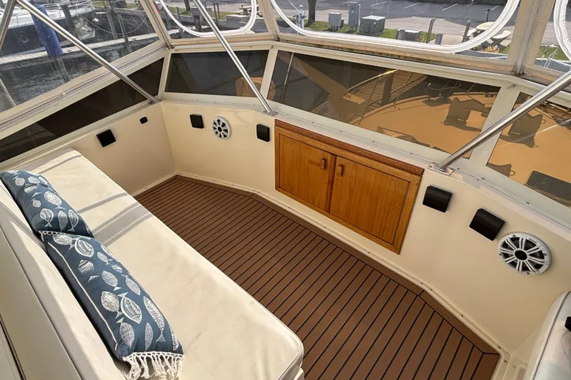  Yacht Photos Pics 1986 Viking 48 Convertible yacht interior with cushioned seating and wooden cabinetry.