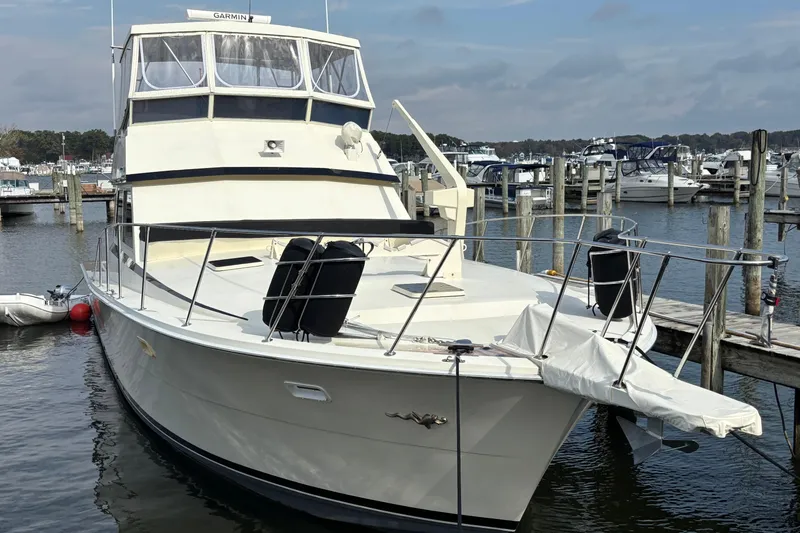 Yacht Photos Pics 1986 Viking 48 Convertible yacht docked at a marina, featuring a spacious deck.