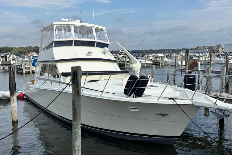  Yacht Photos Pics 1986 Viking 48 Convertible yacht docked at a marina, featuring a spacious deck and flybridge.