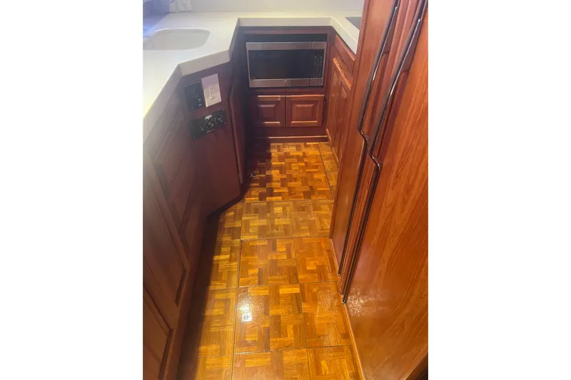  Yacht Photos Pics 1986 Viking 48 Convertible yacht kitchen with wood cabinetry and parquet flooring.