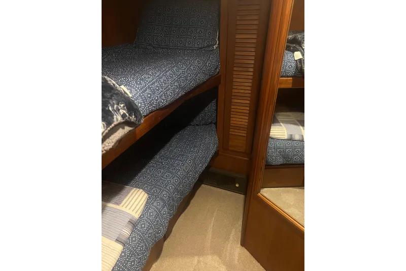  Yacht Photos Pics Bunk beds with blue patterned bedding in 1986 Viking 48 Convertible yacht cabin.
