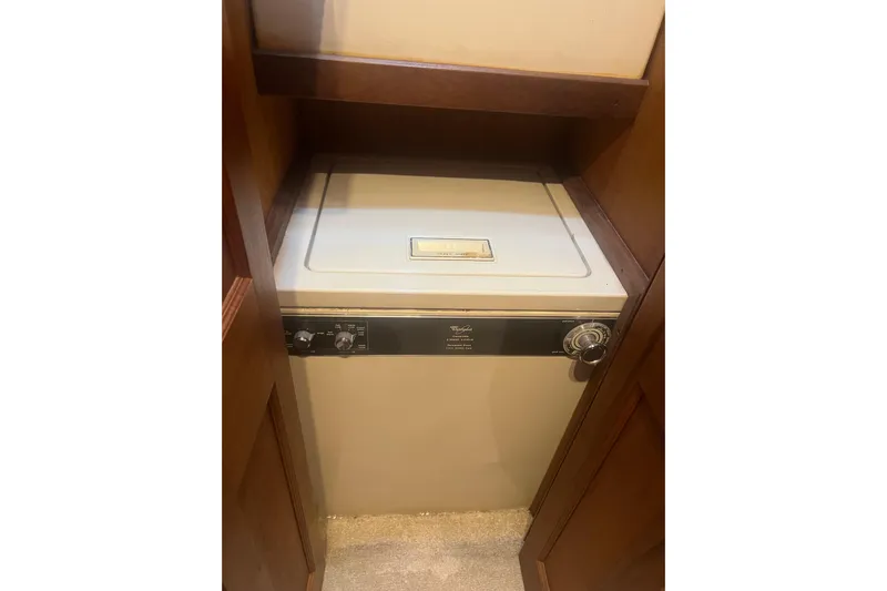  Yacht Photos Pics Washer unit inside a 1986 Viking 48 Convertible yacht, compactly fitted in a wooden cabinet.