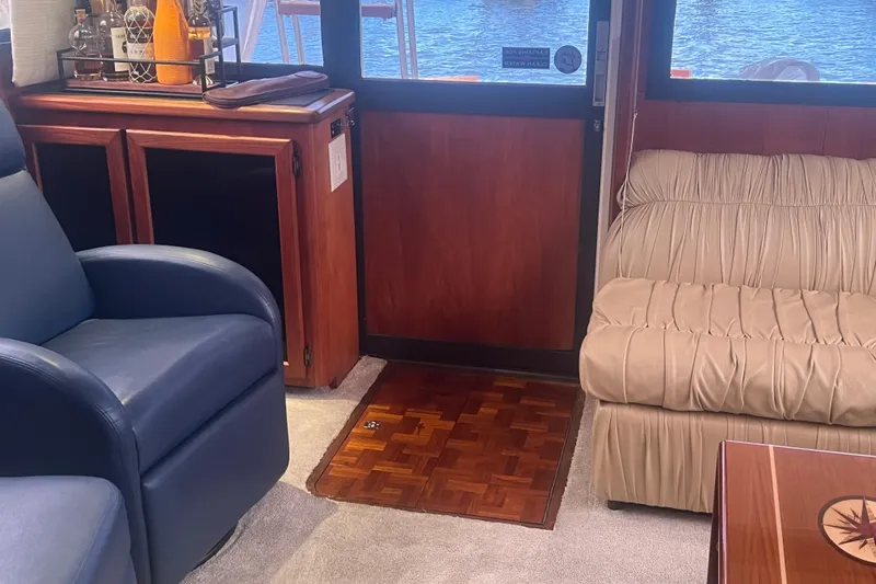  Yacht Photos Pics Interior of 1986 Viking 48 Convertible yacht with plush seating and wooden cabinetry.