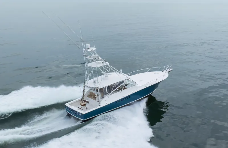 Expresso Yacht Photos Pics 2007 Viking Express boat cruising on open water, showcasing sleek design and powerful performance.