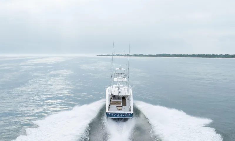 Expresso Yacht Photos Pics A 2007 Viking Express boat cruising on calm waters under a cloudy sky.