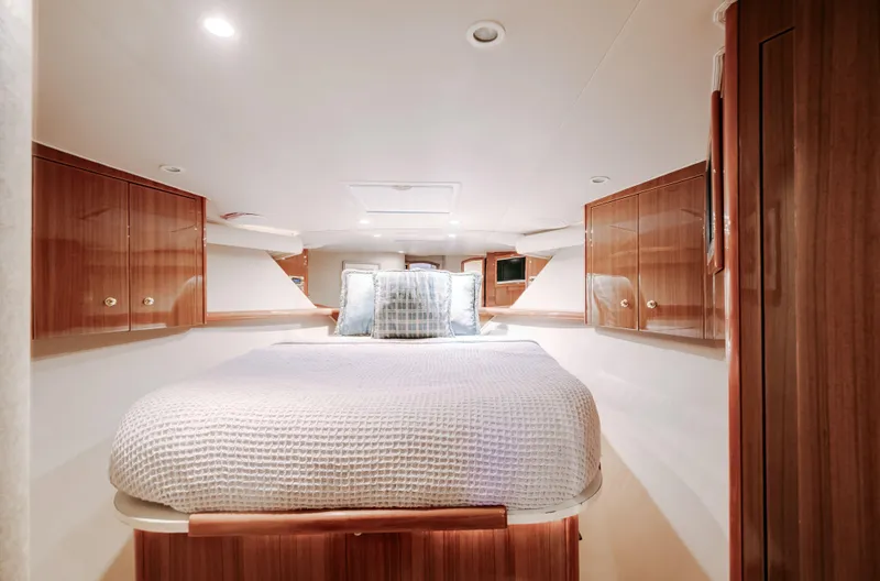 Expresso Yacht Photos Pics Luxurious cabin interior of 2007 Viking Express yacht with cozy bed and wooden cabinetry.