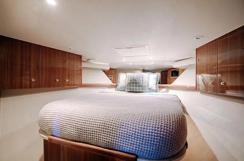 Expresso Yacht Photos Pics Luxurious cabin interior of 2007 Viking Express yacht with cozy bed and wooden cabinets.