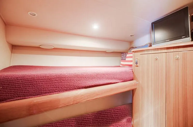 Expresso Yacht Photos Pics Cozy cabin interior of 2007 Viking Express with bunk bed and TV.