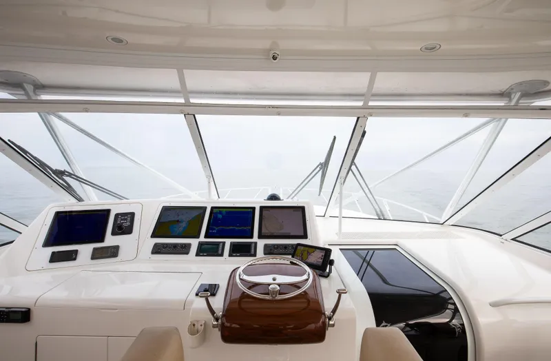 Expresso Yacht Photos Pics 2007 Viking Express boat cockpit with navigation screens and steering wheel.