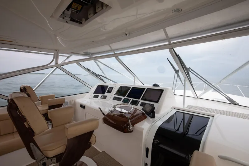 Expresso Yacht Photos Pics Interior of 2007 Viking Express yacht cockpit with navigation screens and leather seats.