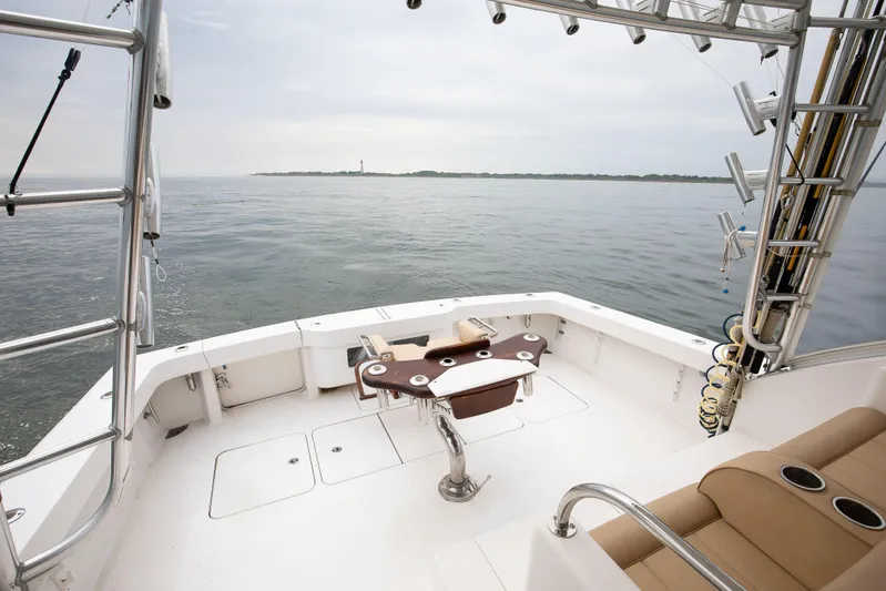 Expresso Yacht Photos Pics 2007 Viking Express boat deck with ocean view and fishing equipment.