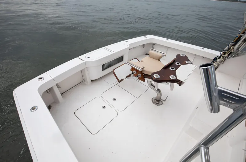 Expresso Yacht Photos Pics 2007 Viking Express boat deck with fishing chair on calm water.