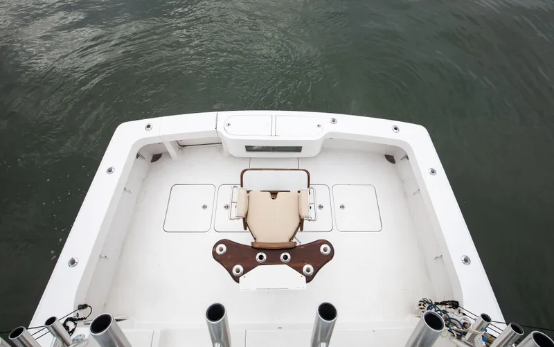 Expresso Yacht Photos Pics 2007 Viking Express boat deck with fishing chair and rod holders on calm water.