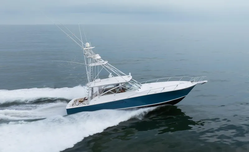 Expresso Yacht Photos Pics 2007 Viking Express yacht cruising on open water, showcasing sleek design and powerful performance.