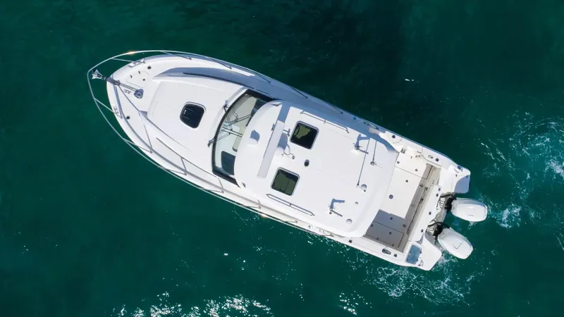 Yacht Photos Pics Aerial view of 2020 Boston Whaler 325 Conquest boat on clear blue water.