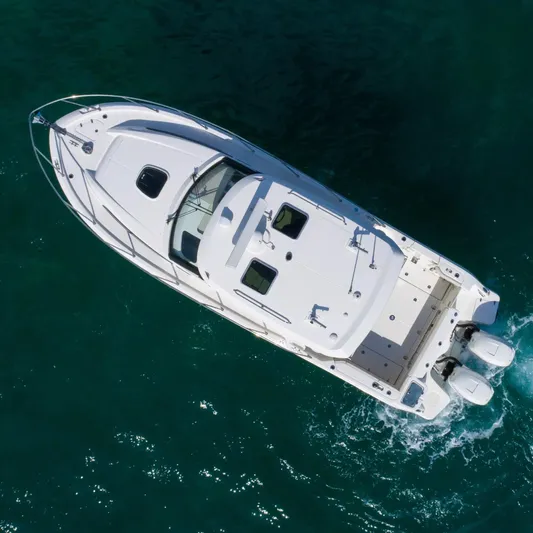  Yacht Photos Pics Aerial view of 2020 Boston Whaler 325 Conquest boat cruising on clear water.