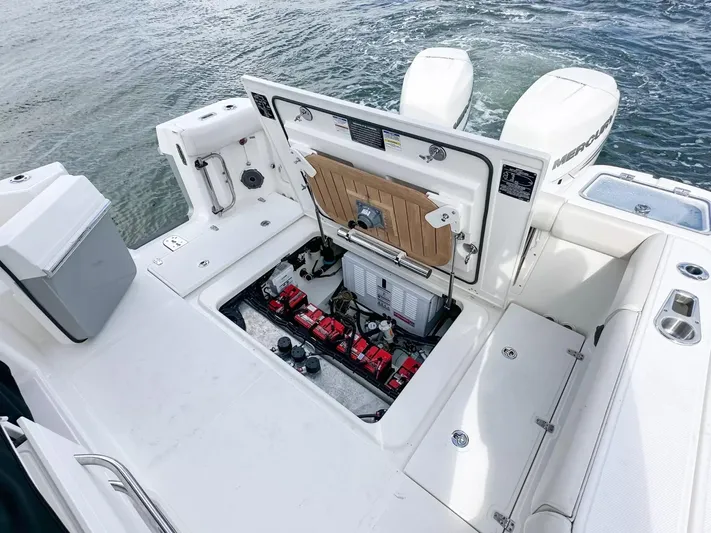  Yacht Photos Pics 2020 Boston Whaler 325 Conquest boat with open engine compartment, twin Mercury outboards.